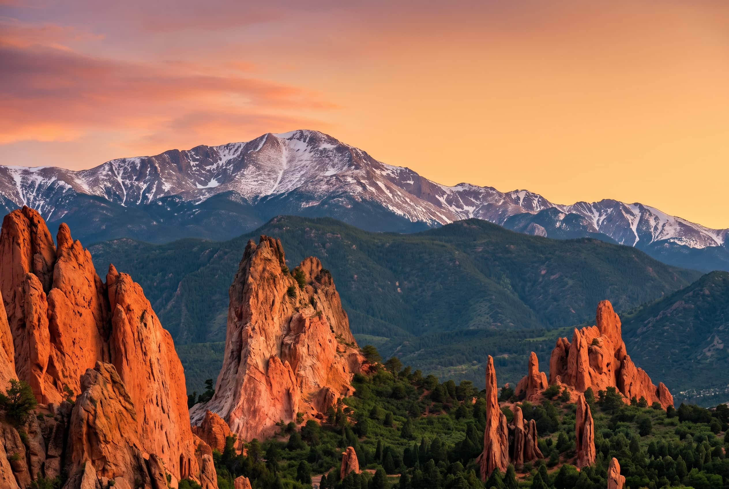 Garden of the Gods red-rock spires and snow-capped Pikes Peak at golden hour